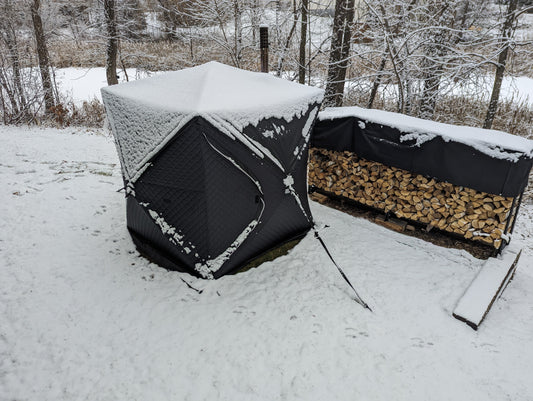 Ox Sweat Sauna Tent with snow and new stack of birch firewood by it