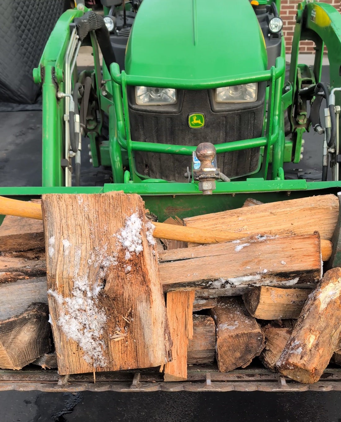 The recommended Sauna firewood hauled in a tractor bucket 